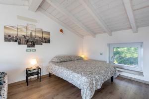 a bedroom with a bed and a window at La Casa In Collina Con Vista in Grezzana