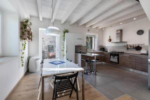 a kitchen with a table and chairs in a room at La Casa In Collina Con Vista in Grezzana