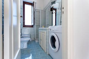 a bathroom with a washing machine and a toilet at Villa Stella in Marsala +36 photos