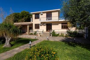 a large white house with a garden in front of it at Villa Stella in Marsala