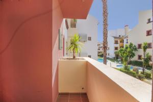 a view from the balcony of a building with a palm tree at Saadia Golf in Huelva