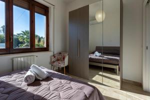 a bedroom with a bed and a mirror at Villa Stella in Marsala