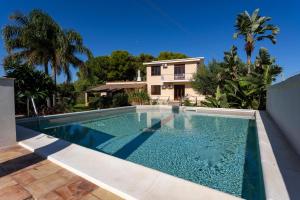 a swimming pool in front of a house at Villa Stella in Marsala
