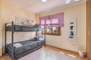 a bedroom with two bunk beds and a window at Saadia Golf in Huelva +18 photos