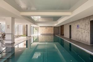 a swimming pool in a building with a swimming pool at 2 Zimmer Appartement mit Pool in Schluchsee