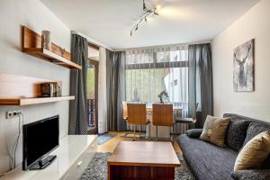 a living room with a couch and a table at 2 Zimmer Appartement mit Pool in Schluchsee