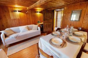 a living room with a table and a white couch at Sweet Somma Mountain Lodge 2 in San Guglielmo +24 photos