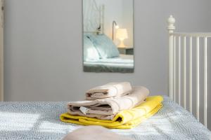 a pile of towels sitting on a table in a bedroom at Apartamento Can Roses in Moscari +15 photos