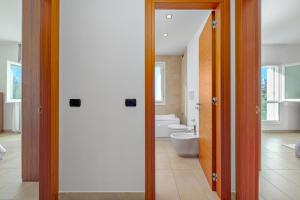 a bathroom with a toilet and a sink at Villa Marconi Apartment 7 in Golfo Aranci +19 photos