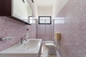 a bathroom with a white sink and a toilet at Villa Tina a Torre Lapillo in Torre Lapillo +20 photos