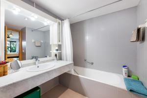 a bathroom with a sink and a tub and a mirror at Ca Na Bel in Port de Soller +17 photos