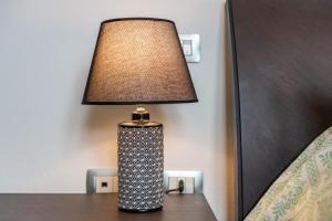 a lamp sitting on a table next to a bed at villa Isabel 2 in Villasimius