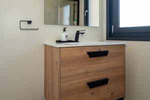 a bathroom vanity with a sink and a mirror at Casa Muxía Mar y montaña in Muxia +32 photos