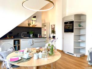 a kitchen and dining room with a table in a room at Ferienwohnung Fernblick in Königsberg in Bayern +11 photos