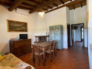 a dining room with a table and chairs at I Profumi Dell'Orto - Campagnatico in Campagnatico
