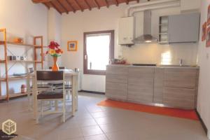 a kitchen with a table and a dining room at The Comfort Apartment in Montagnana