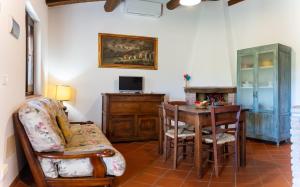 a living room with a table and a chair and a desk at I Profumi Dell'Orto - Campagnatico in Campagnatico