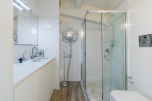 a bathroom with a shower and a toilet and a sink at Elvi Suite Vista Mare Marzamemi in Marzamemi +15 photos