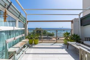 a balcony with benches and a view of the ocean at Elvi Suite Vista Mare Marzamemi in Marzamemi