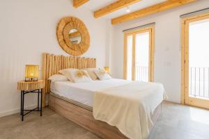 a bedroom with a bed and a mirror on the wall at Cas Suis 7 in Campanet +50 photos