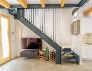 a blue staircase in a living room with a tv at Cas Suis 7 in Campanet
