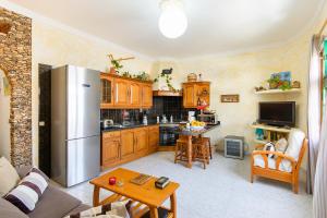 a kitchen with wooden cabinets and a stainless steel refrigerator at El Golfo Lanzarote in El Golfo