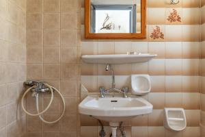 a bathroom with a sink and a mirror at Perasma Studio 1 in Kipri +12 photos