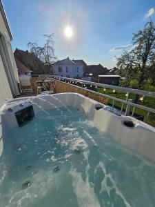 a hot tub on the back of a house at Wohlfühloase nähe Messe in Sehnde