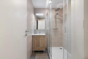 a bathroom with a shower and a sink and a mirror at Telmus Villa Rc in Monte Gordo +27 photos