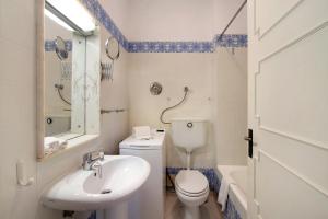 a white bathroom with a sink and a toilet at Villa Apfel in Vale do Lobo +13 photos