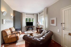 a living room with a couch and a table at Villa Apfel in Vale do Lobo