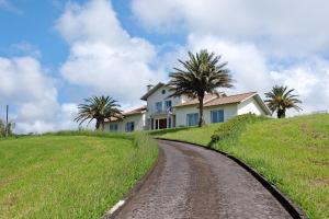 a house on a hill with a dirt road at Casa Do Monte in Achadinha