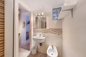 a bathroom with a sink and a toilet at Goccia di mare with free parking in Levanto