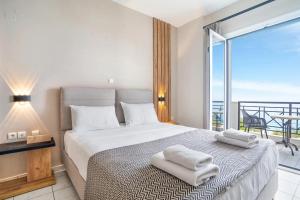 a bedroom with a bed with towels on it at Sunset Premium Studio 6 in Lefkada