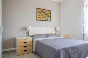a bedroom with a bed and a picture on the wall at Trilocale colline di Bardolino in Bardolino