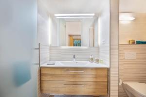a bathroom with a sink and a mirror at Appartements Gabrielli Anna in Trodena +13 photos
