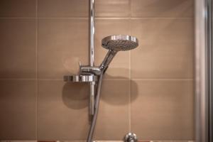 a shower in a bathroom with a shower head at Al Cornelio in Orvieto +14 photos