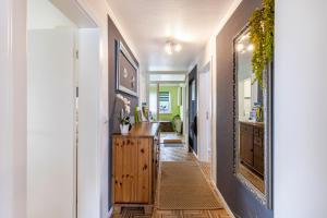 a hallway of a home with a vanity and a mirror at Baumelt Ferienwohnung in Hechingen