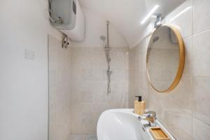 a bathroom with a sink and a mirror at Casetta l'Ulivo in Poggi +12 photos