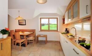a kitchen with a table and a dining room at Mitterhof in Villandro