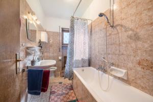 a bathroom with a tub and a sink and a toilet at Apartement Oase in Lana +14 photos