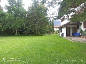 a yard of a house with a green lawn at Apartement Oase in Lana