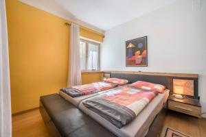 a bedroom with a bed and a couch at Apartement Oase in Lana