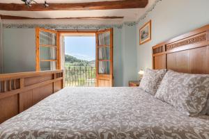 a bedroom with a large bed and a window at El Cup in San Martín de Tous +26 photos
