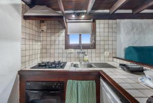 a kitchen with a sink and a stove top oven at Tesbabo Rural - Mimo in Mocanal +13 photos