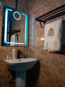 a bathroom with a sink and a mirror and a towel at Joebrown Palace Hotel & Suite in Akitan +14 photos