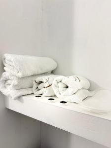 a white shelf with towels on top of it at Vila JONI in Berat +25 photos