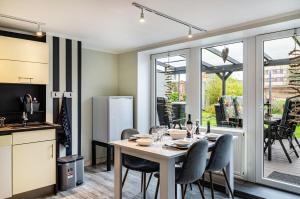a kitchen and dining room with a table and chairs at Femeer 01 in Wilhelmshaven