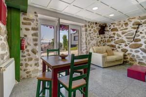 a living room with a table and chairs and a couch at Quinta Santa Marinha in Arcos de Valdevez