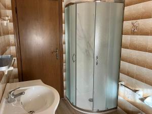 a bathroom with a shower and a sink at Luna Apartment in Rimini